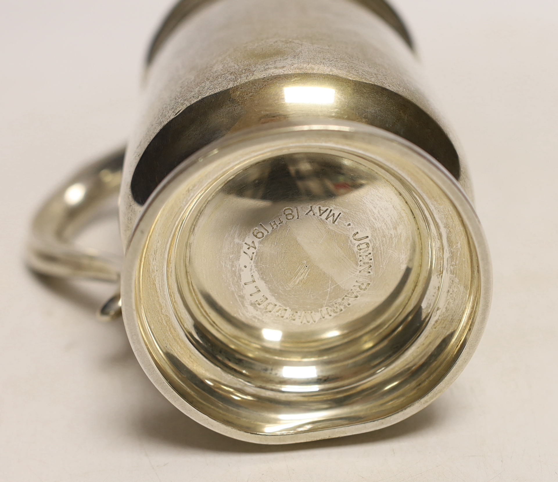 A George V silver mug, with engraved armorial, A & J Zimmerman, Birmingham, 1930, 13cm, 9oz.